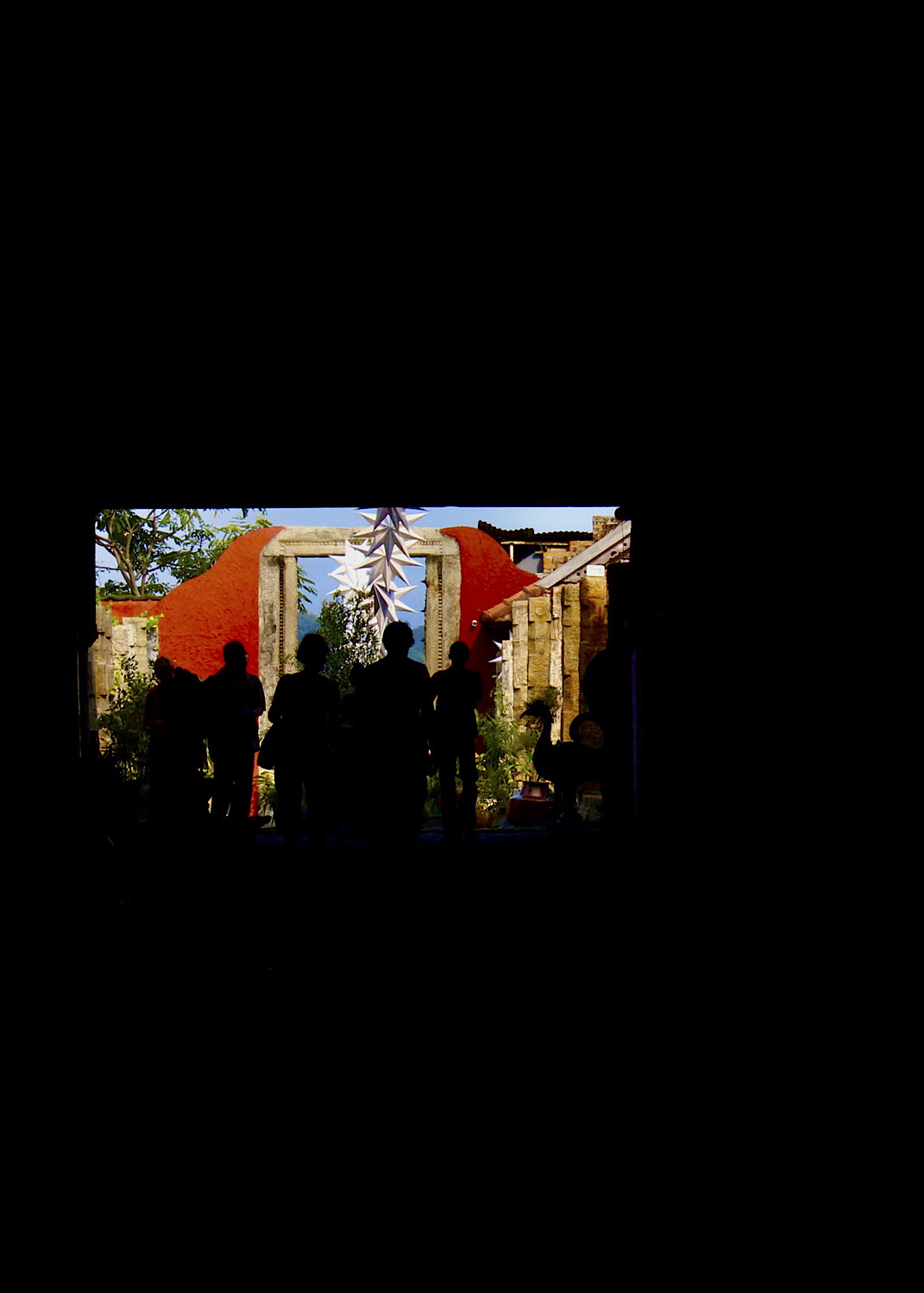 Silhouetted figures in doorway backlit against colorful architectural background - architectural photography